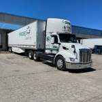 Pride Group Logistics truck on the highway, representing the company's sale back to the founding Johal family after creditor protection under CCAA.